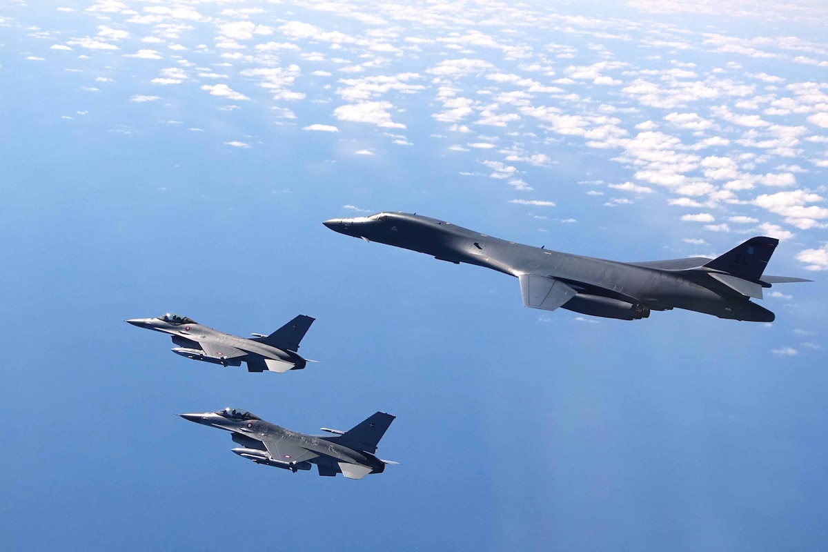 Three aircraft fly against a blue sky.