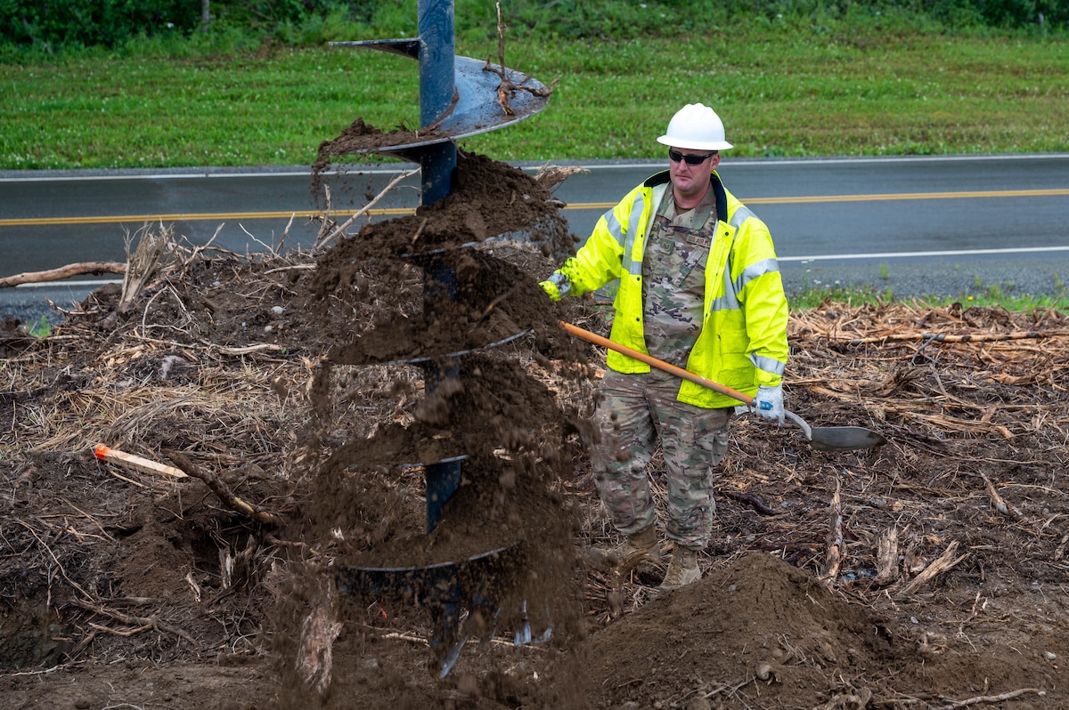Tech Sgt. Andrew Brinza, a 934th Airlift Wing Civil Engineering Squadron structures craftsman, removes the dirt off of heavy machinery during the upgrade of Camp Mad Bull’s electrical system at Joint Base Elmendorf-Richardson, Alaska, on Aug. 9, 2023. The 934 AW CES was at the site for over two months in a series of 3 different rotations to effectively complete the mission. (Air Force photo by Senior Airman Matthew Reisdorf)