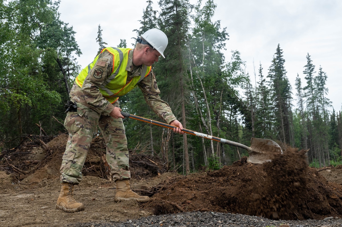 Senior Airman Nathan Smith, a 934th Airlift Wing Civil Engineering Squadron engineering journeyman, fills a back trench while upgrading Camp Mad Bull’s electrical system at Joint Base Elmendorf-Richardson, Alaska, on Aug. 9, 2023. The 934 AW CES was at the site for over two months in a series of 3 different rotations to effectively complete the mission. (Air Force photo by Senior Airman Matthew Reisdorf)