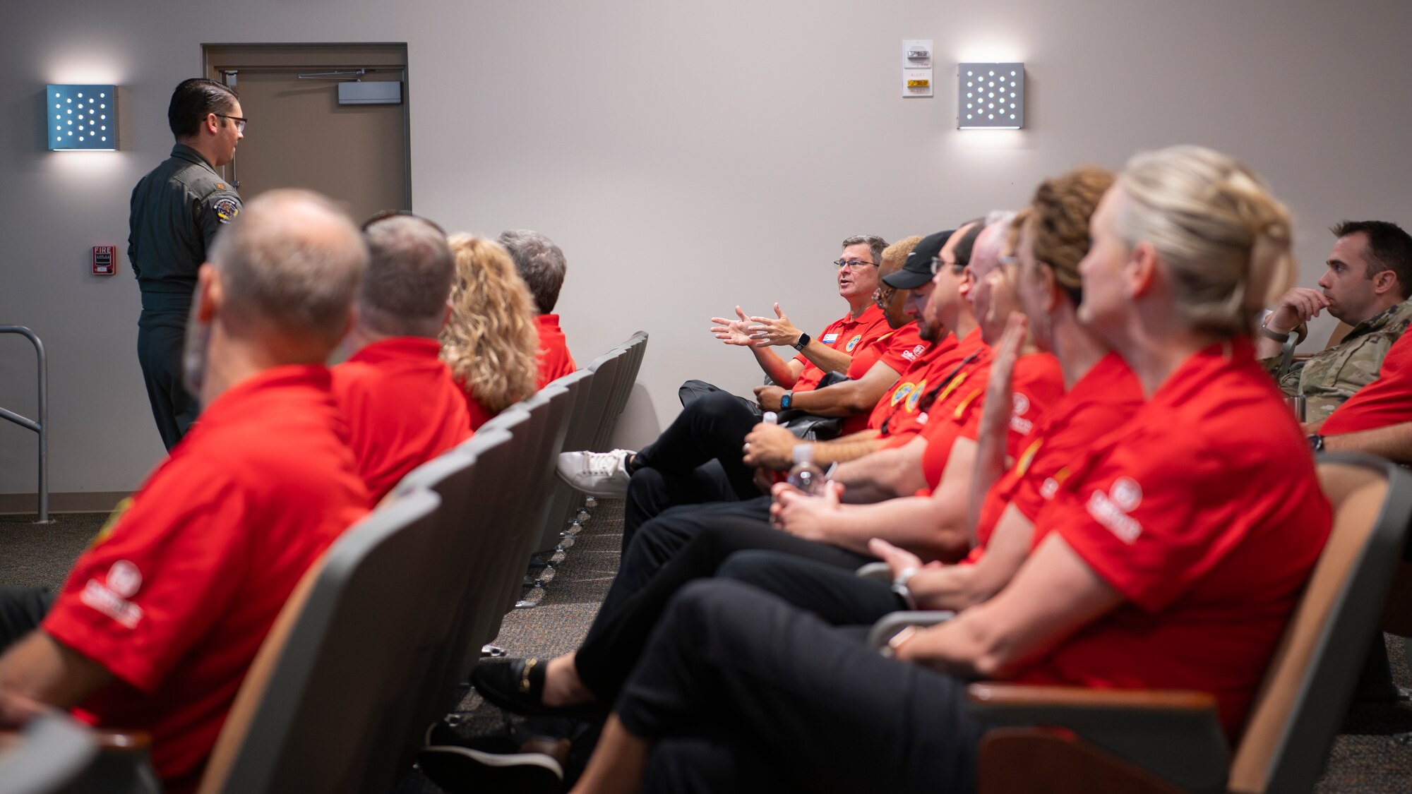 People sit during a briefing