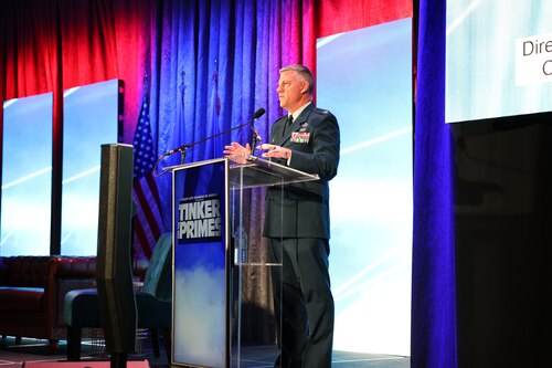 Man speaking at podium on stage