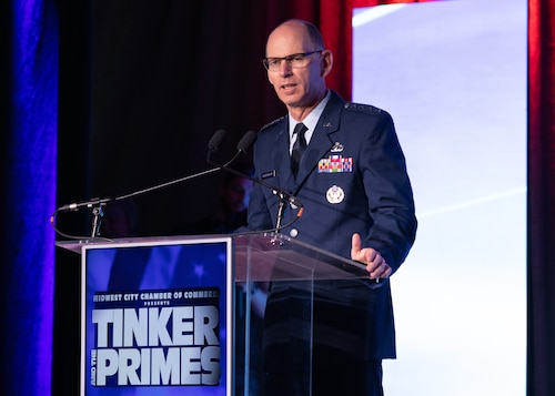 Man in Air Force uniform speaking at podium