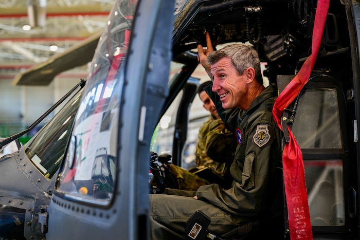 U.S. Air Force Maj Gen. Thomas E. Kunkel, NATO Airborne Early Warning and Control commander, sits in an HH-60G Pave Hawk and admires the upgrades made.