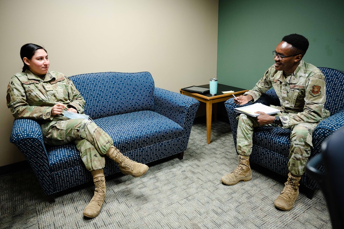 Senior Airman Kiige, 2nd Medical Group mental health technician, speaks to Senior Airman Emma Gomez-Felix, 2nd Medical Group ADAPT technician.