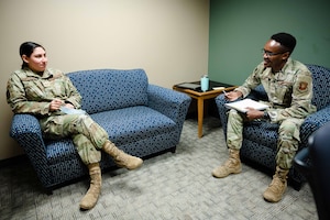 Senior Airman Kiige, 2nd Medical Group mental health technician, speaks to Senior Airman Emma Gomez-Felix, 2nd Medical Group ADAPT technician.