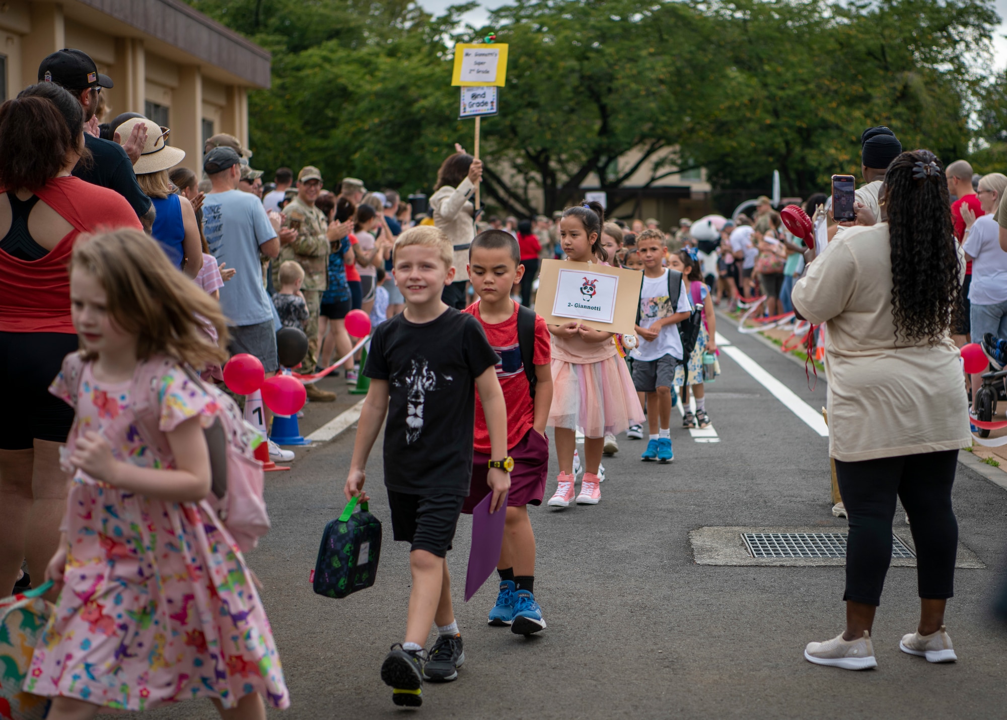 Students walk towards a school building.