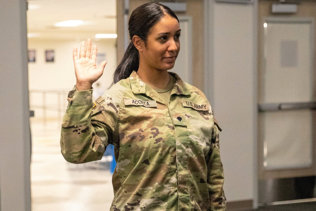 U.S. Pennsylvania Army National Guard Soldier Spc. Jennifer Acosta Tejada, 55th Maneuver Enhancement Brigade (MEB), 28th Infantry Division, takes the Naturalization Oath of Allegiance to the United States of America while serving on a CONUS mission to become an official U.S. citizen on August 10, 2023. Acosta, originally from the Dominican Republic, received her citizenship through her military service with the Pennsylvania Army National Guard under the Naturalization Through Service program. (U.S. Army photo by Sgt. Vail Forbeck)