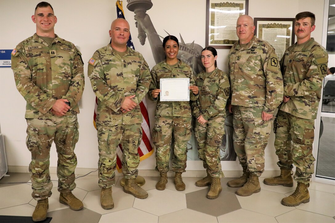 U.S. Pennsylvania Army National Guard Soldier Spc. Jennifer Acosta Tejada, 55th Maneuver Enhancement Brigade (MEB), 28th Infantry Division, celebrates her U.S. citizenship with members of the 55th MEB after taking the Naturalization Oath of Allegiance to the United States of America while serving on a CONUS mission on August 10, 2023. Acosta, originally from the Dominican Republic, received her citizenship through her military service with the Pennsylvania Army National Guard under the Naturalization Through Service program. (U.S. Army photo by Sgt. Vail Forbeck)