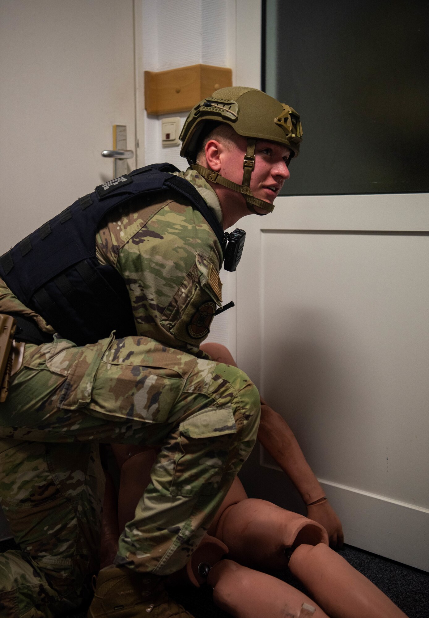Airman examines dummy.
