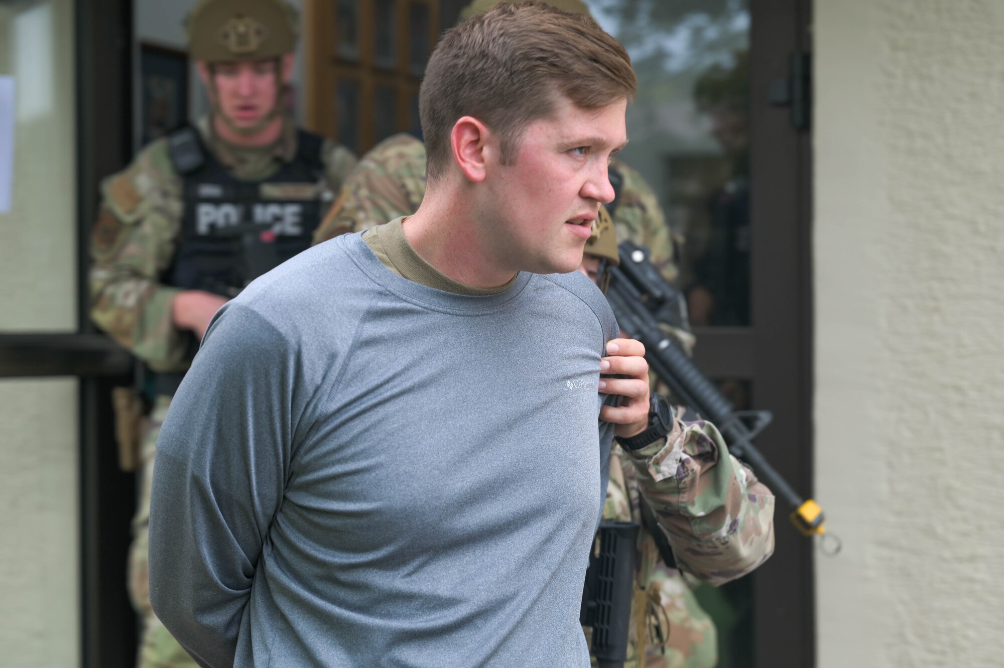 Airmen is lead out of building.