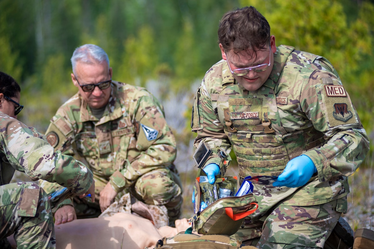 U.S. Air Force Senior Airman Jacob Lowell, right, a medical technician with the 110th Medical Group uses innovative technology to treat a simulated patient during a field exercise as part of exercise Northern Strike 23 (NS23),