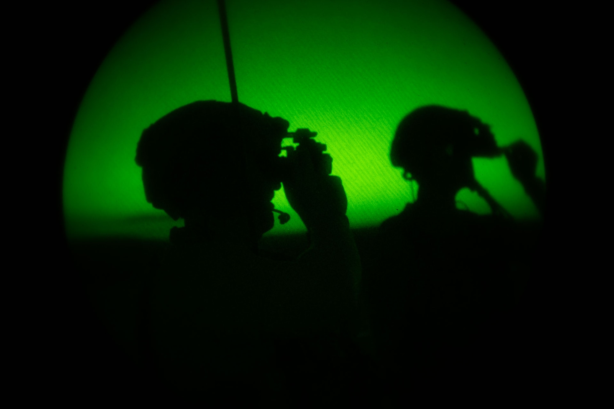 TACPs look through night vision goggles in a green and black image