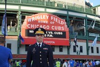 Capt. Michael Ariola, Public Affairs Officer, 85th U.S. Army Reserve Support Command, stands in front of the iconic Wrigley Field marquee sign August 16, 2023.