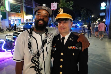 Capt. Michael Ariola, right, Public Affairs Officer, 85th U.S. Army Reserve Support Command, pauses for a photo with a Chicago White Sox fan outside Wrigley Field, following the Crosstown Series game featuring the Cubs versus the White Sox.