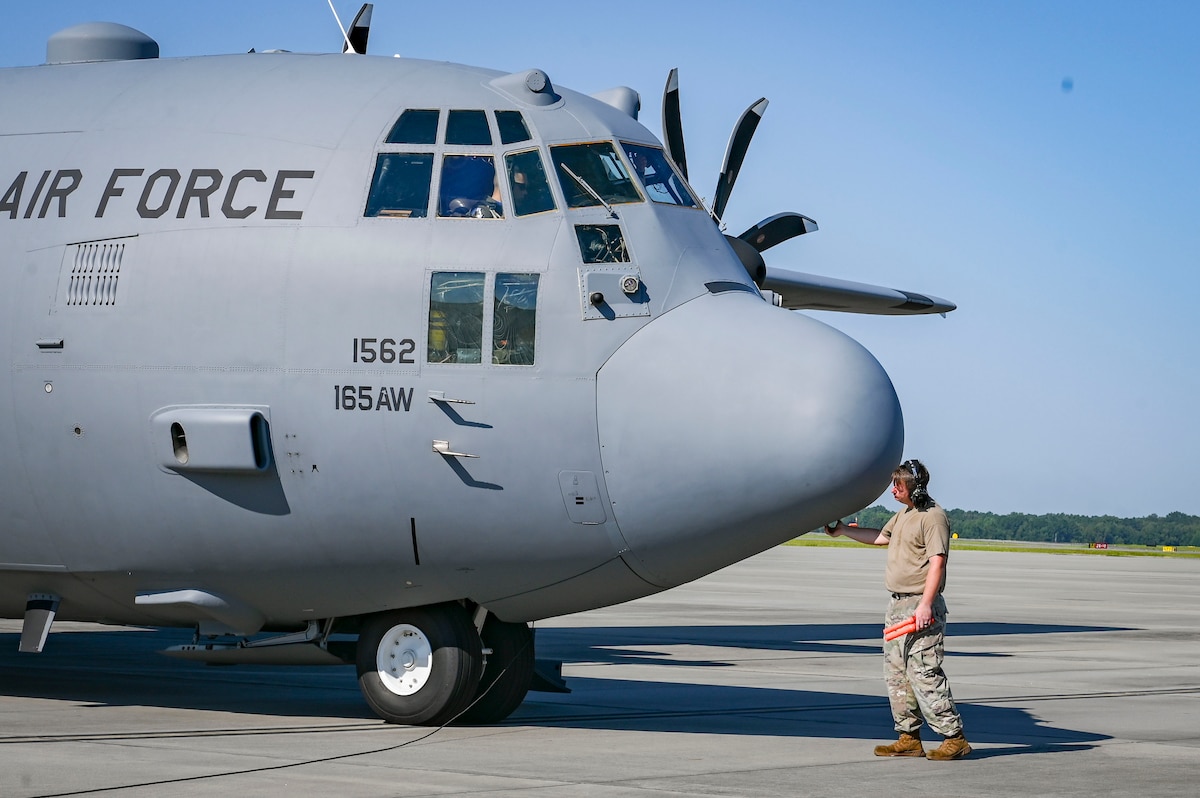 U.S. Air Force Tech. Sgt. Justin Douglas, a crew chief assigned to the 165th Maintenance Group, 165th Airlift Wing, Georgia National Guard, gives a C-130 Hercules aircraft a final pat as a farewell gesture prior to the aircraft departing Savannah Air National Guard Base, Georgia, August 18, 2023.