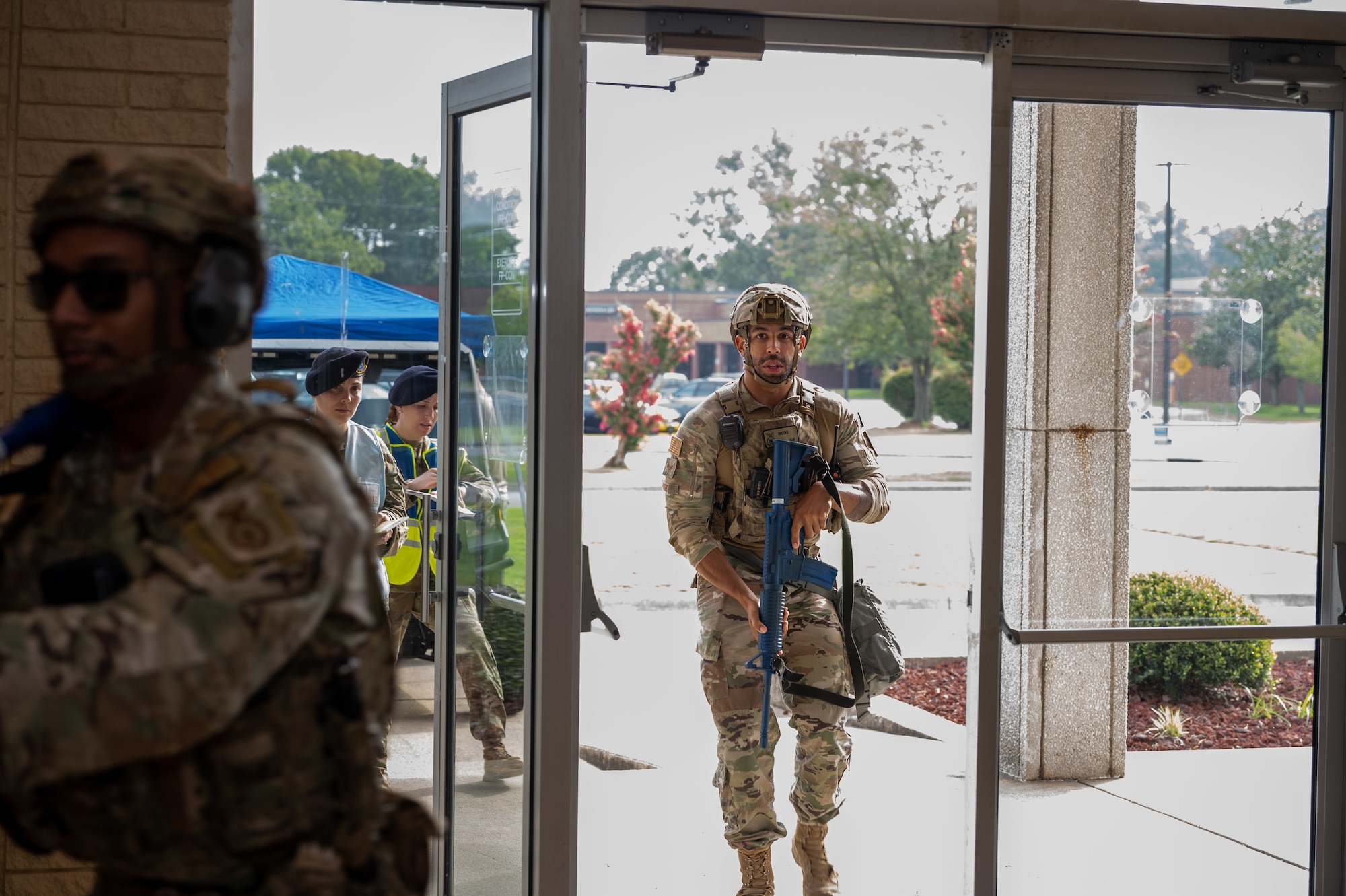 U.S. Air Force Airmen assigned to the 4th Security Forces Squadron enter a theater to respond to a simulated active shooter threat during an active-shooter training exercise at Seymour Johnson Air Force Base, North Carolina, August 17, 2023. Airmen trained side-by-side with Wayne County first responders during the exercise to bolster communication and operational readiness between military and civilian personnel.  (U.S. Air Force photo by Airman 1st Class Leighton Lucero)