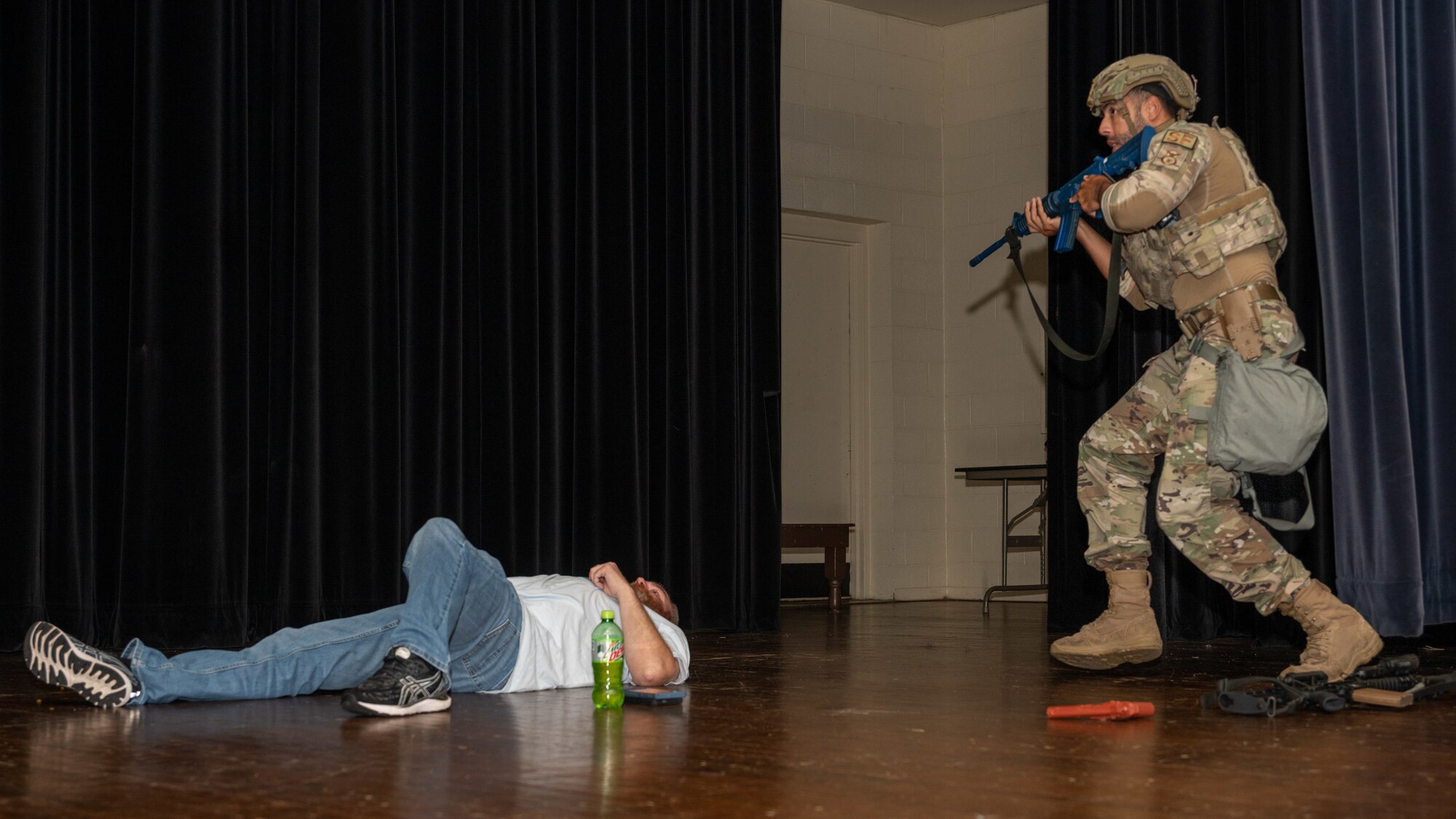 A U.S. Air Force Airman assigned to the 4th Security Forces Squadron approaches a simulated neutralized threat during an active-shooter training exercise at Seymour Johnson Air Force Base, North Carolina, August 17, 2023. Active-shooter exercises like this test the ability of first responders from the base and local community to save lives and neutralize a threat. (U.S. Air Force photo by Airman 1st Class Leighton Lucero)