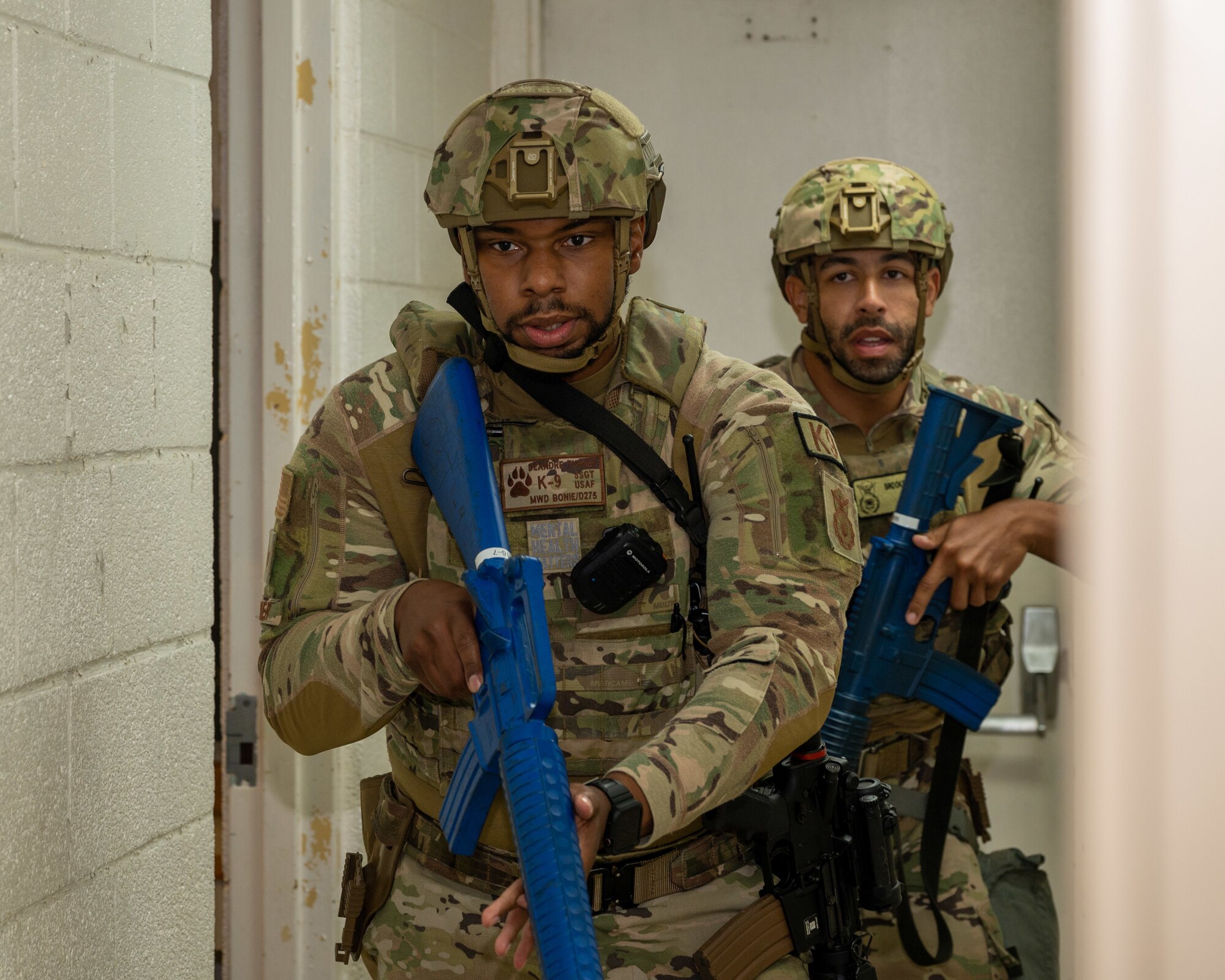 U.S. Air Force Airmen assigned to the 4th Security Forces Squadron sweep-and-clear a theater in response to a simulated active shooter threat during an active-shooter training exercise at Seymour Johnson Air Force Base, North Carolina, August 17, 2023. Airmen trained side-by-side with Wayne County first responders during the exercise to bolster communication and operational readiness between military and civilian personnel. (U.S. Air Force photo by Airman 1st Class Leighton Lucero)