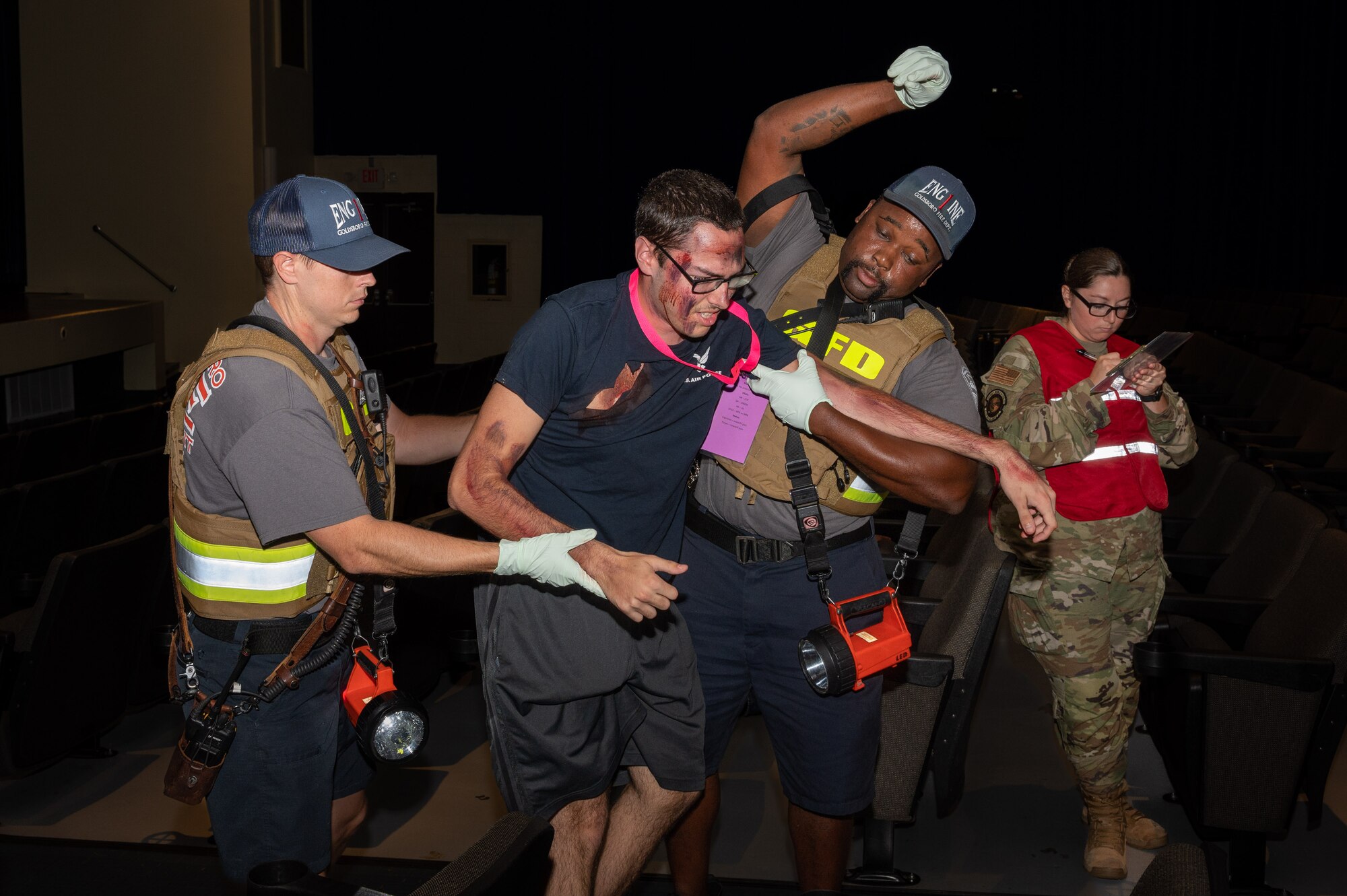 Wayne County first responders assist a simulated casualty to an ambulance during an active-shooter training exercise at Seymour Johnson Air Force Base, North Carolina, August 17, 2023. Active-shooter exercises like this test the ability of first responders from the base and local community to save lives and neutralize a threat. (U.S. Air Force photo by Airman 1st Class Leighton Lucero)