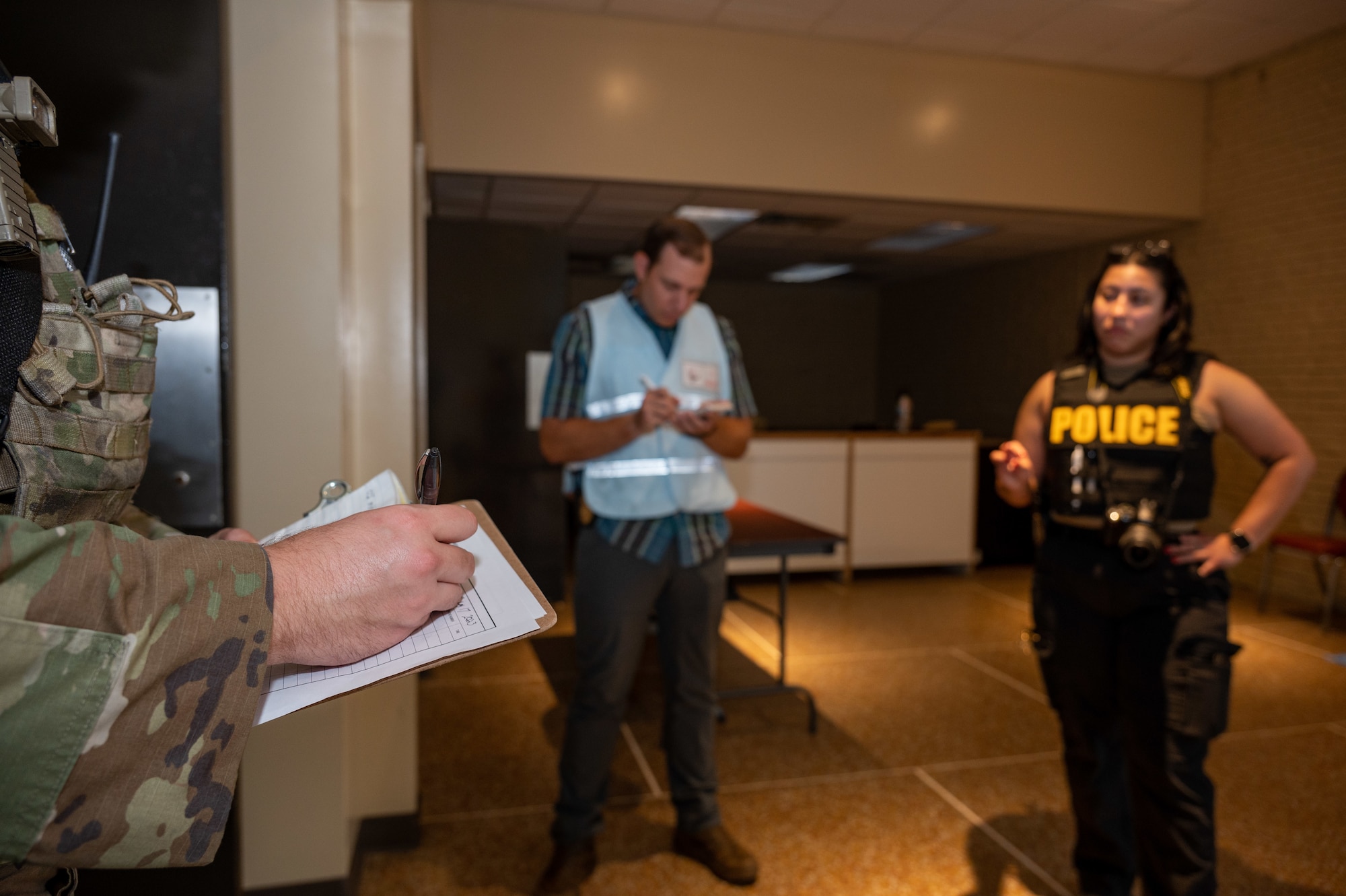 U.S. Air Force Airmen assigned to the 4th Security Forces Squadron’s Office of Special Investigations annotate and compile information regarding a simulated active-shooter incident during an active-shooter training exercise at Seymour Johnson Air Force Base, North Carolina, August 17, 2023. Active-shooter exercises like this test the ability of first responders from the base and local community to save lives and neutralize a threat. (U.S. Air Force photo by Airman 1st Class Leighton Lucero)