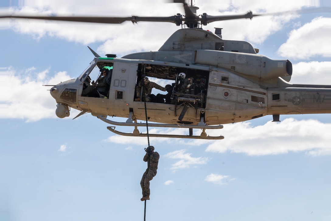 A U.S. Marine with Lima Co., 3rd Battalion, 1st Marine Regiment, Marine Rotational Force Darwin 23 fast ropes out of a UH-1Y Venom helicopter at Robertson Barracks, Northern Territory, Australia, Aug. 14, 2023. Through increased training with allies and partners, MRF-D is postured and ready to respond to crisis and contingency in the region, contributing to a safe and prosperous Indo-Pacific.