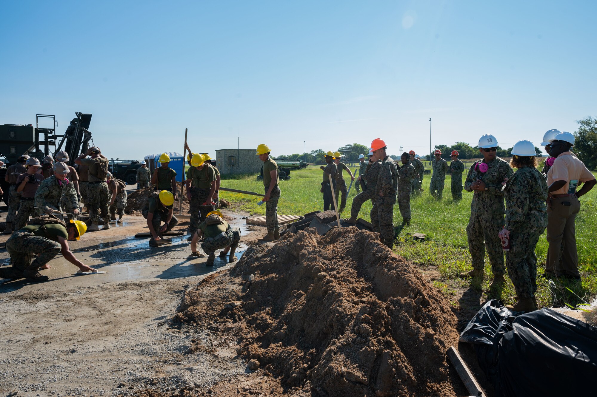 U.S. Navy Capt. Constance Solina, commodore of Naval Construction Group TWO (NCG 2), tours the airfield damage repair exercise area during Large-Scale Exercise 2023 (LSE 2023) at Seymour Johnson Air Force Base, North Carolina, August 11, 2023. LSE 2023 demonstrates the Navy’s and Marine Corps’ ability to employ precise, lethal, and overwhelming force globally across six maritime component commands, seven numbered fleets, and 22 time zones. LSE 2023 merges real-world operations with virtually constructed scenarios to create a realistic training environment that allows Sailors and Marines to train how they will fight, regardless of geographic boundaries. (U.S. Air Force photo by Rebecca Sirimarco-Lang)