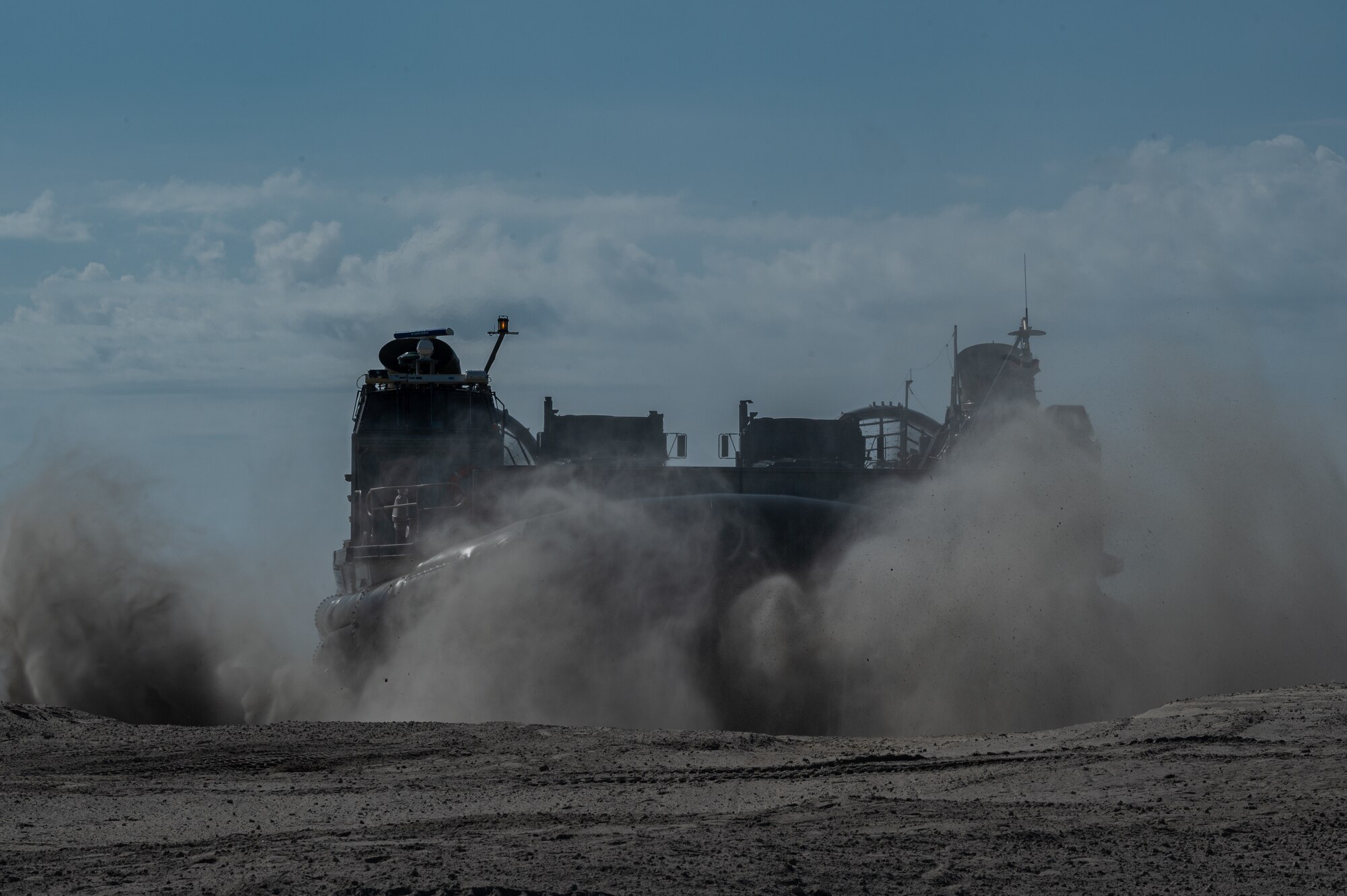 Navy Expeditionary Combat Command Seabees assigned to Naval Mobile Construction Battalion 11 are delivered to shore by U.S. Navy Landing Craft, Air Cushion (LCAC) 83 at Onslow Beach, Marine Corps Base Camp Lejeune, North Carolina, August 9, 2023, during Large-Scale Exercise 2023 (LSE 2023). LSE 2023 demonstrates the Navy’s and Marine Corps’ ability to employ precise, lethal, and overwhelming force globally across six maritime component commands, seven numbered fleets, and 22 time zones. LSE 2023 merges real-world operations with virtually constructed scenarios to create a realistic training environment that allows Sailors and Marines to train how they will fight, regardless of geographic boundaries. (U.S. Air Force photo by Airman 1st Class Rebecca Sirimarco-Lang)