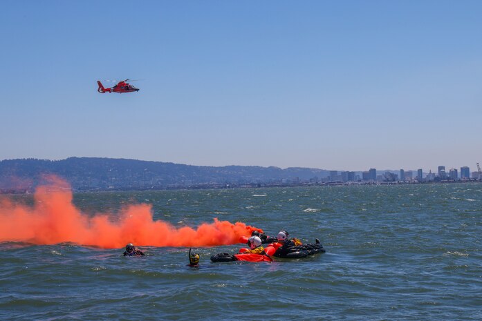 Members of Beale Air Force Base signal to U.S. Coast Guard San Francisco Sector Search and Rescue (SAR) team for evacuation from the San Francisco Bay, California Aug 17, 2023.