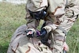 A service member practices administering the high-dose naloxone autoinjector (NAI) as a rescue treatment to counter opioid poisoning.
