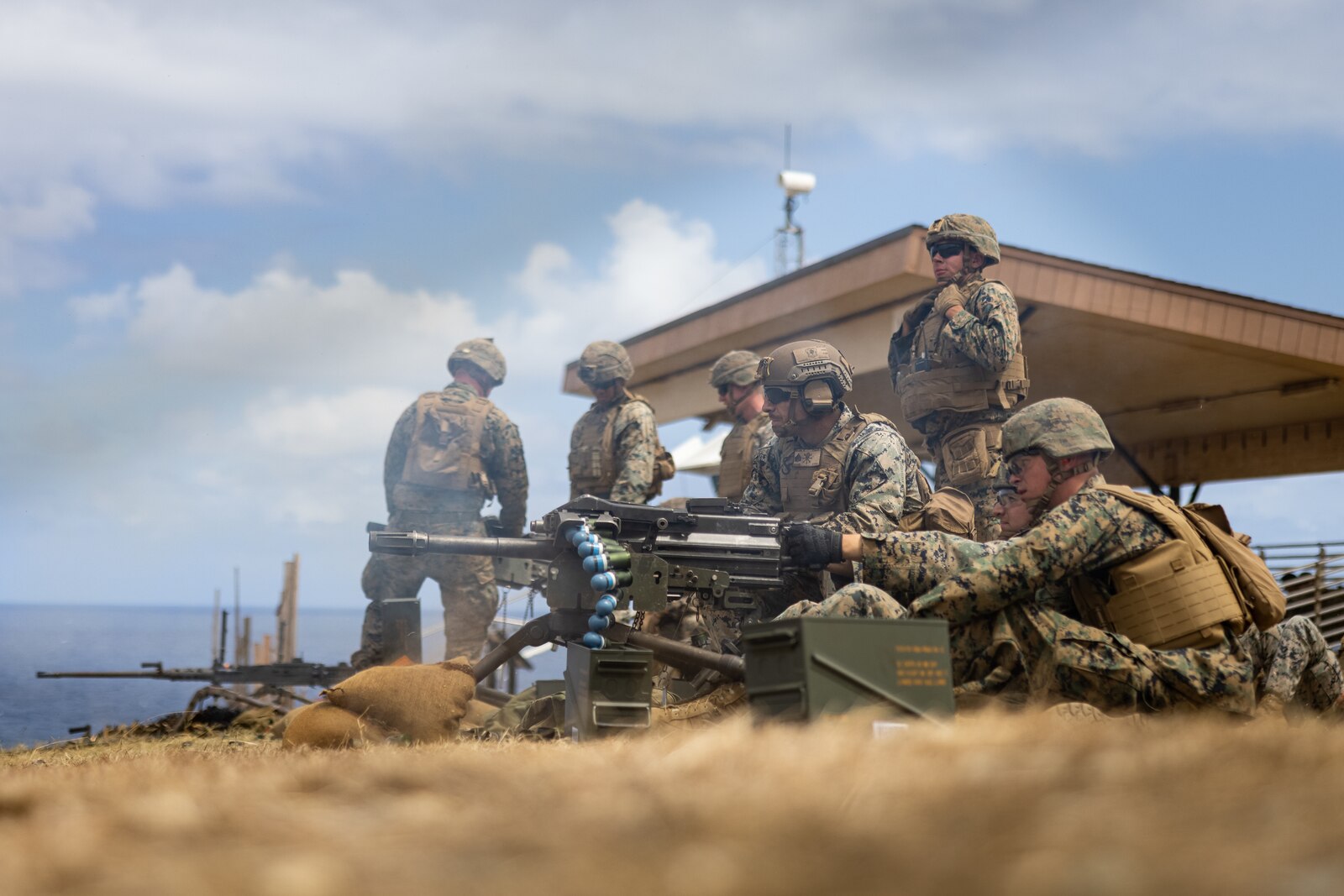U.S. Marines with 3d Littoral Combat Team, 3d Marine Littoral Regiment, 3d Marine Division, fire Mk 19 grenade launchers during a live fire range at Marine Corps Base Hawaii, August 2, 2023. The purpose of this exercise is to sharpen the LCT’s weapons handling skills and increase their readiness for future exercises and operations. (U.S. Marine Corps photo by Lance Cpl. Malia Sparks)