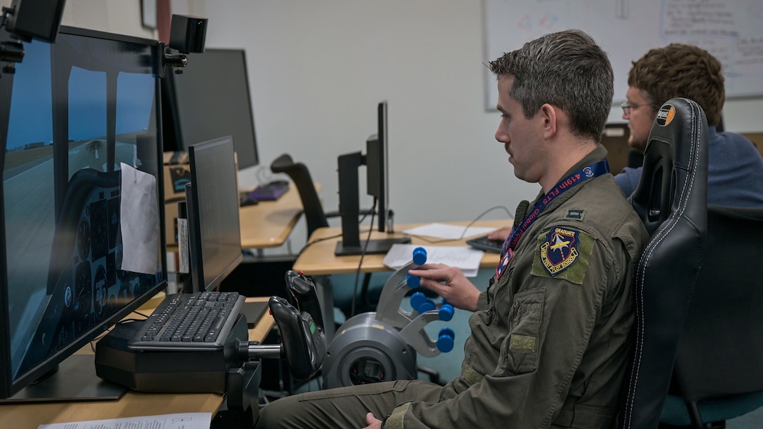 A B-52 Stratofortress test pilot operates a flight simulator while using one of three new flight instrumentation prototype gauge clusters at Edwards Air Force Base, recently. (Air Force photo by Giancarlo Casem)