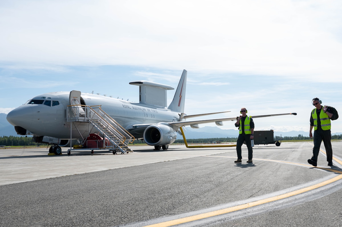 Two RAAF members walk to an E-7A Wedgetail during Red Flag-Alaska