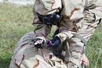 A service member practices administering the high-dose naloxone autoinjector (NAI) as a rescue treatment to counter opioid poisoning.