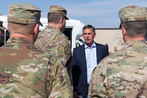 New Mexico Senator Martin Heinrich is greeted by Lt. Gen. Tony Bauernfeind, Air Force Special Operations Command commander, Col. Jeremy Bergin, 27th Special Operations Wing commander, and Chief Master Sgt. Colin Fleck, 27 SOW command chief, during a visit to Cannon Air Force Base, N.M., Aug. 22, 2023. Bauernfeind and the 27 SOW leadership team hosted a meeting to discuss transforming AFSOC force structure for a fifth power projection wing, greater force development, and growth for Air Commandos with congressional and community leaders. (U.S. Air Force photo by Senior Airman Drew Cyburt)
