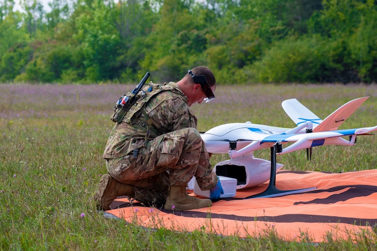 U.S. Air Force Maj. Broc Nichelson, a chief nurse with the 110th Medical Group, receives a package from an unmanned drone during a field exercise as part of Exercise Northern Strike 23 (NS23), Alpena, Michigan, Aug. 14, 2023.