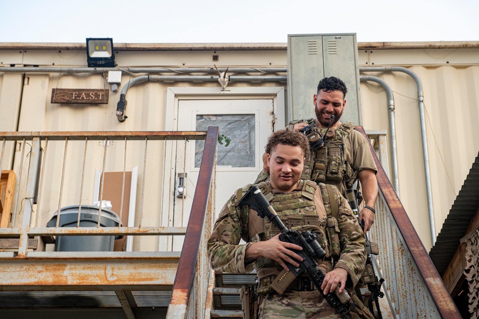 Photo of two men descending stairs