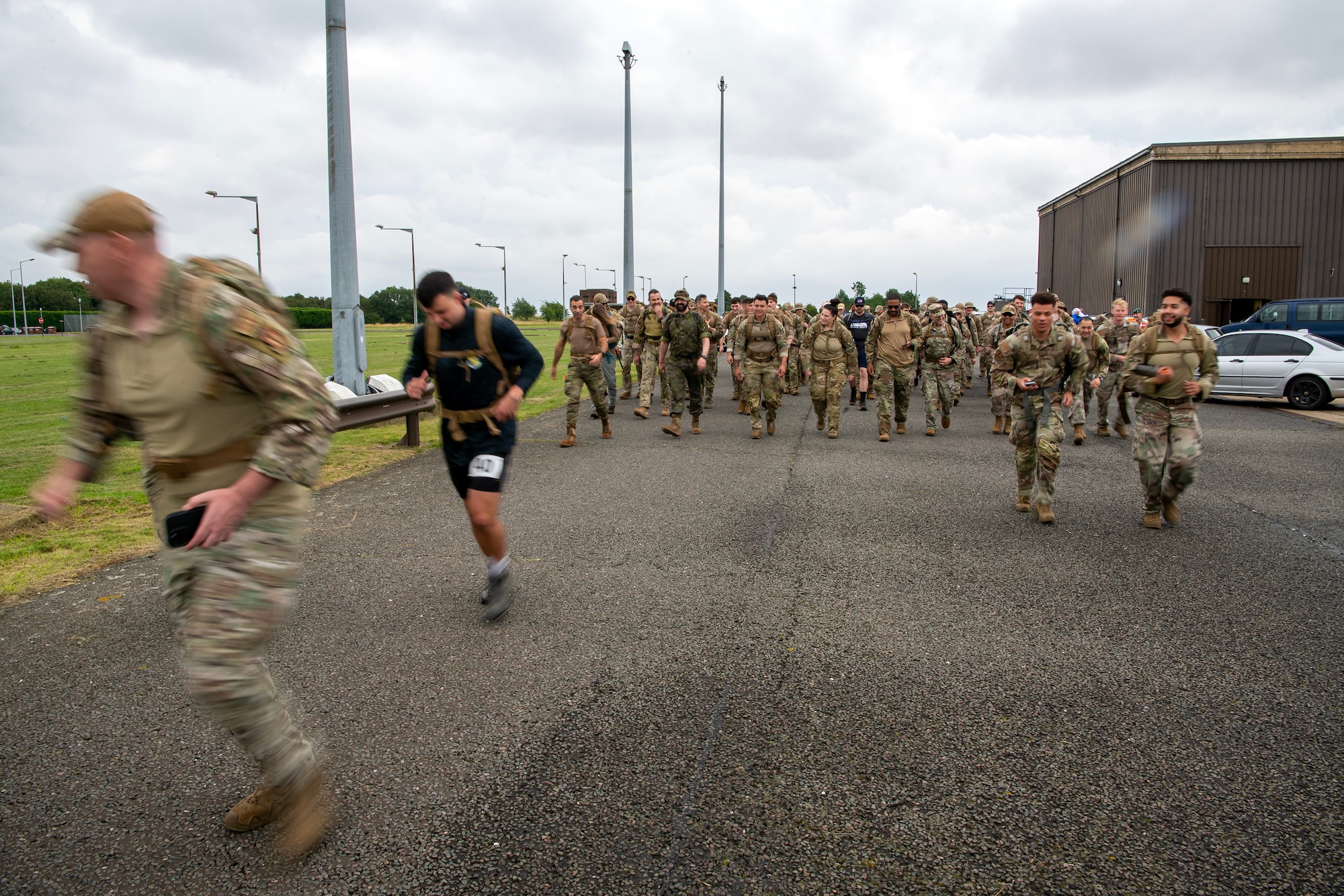 Participants begin a ruck march at RAF Molesworth, England, Aug. 18, 2023. Over 100 personnel from the 501st CSW and mission partner units participated in a 25 Kilometer Danish Contingent ruck march, which allowed them to test their physical capabilities and encouraged social bonds between joint forces. The DANCON ruck march has been completed in numerous countries throughout the world since it was established in 1972. (U.S. Air Force photo by Staff Sgt. Eugene Oliver)
