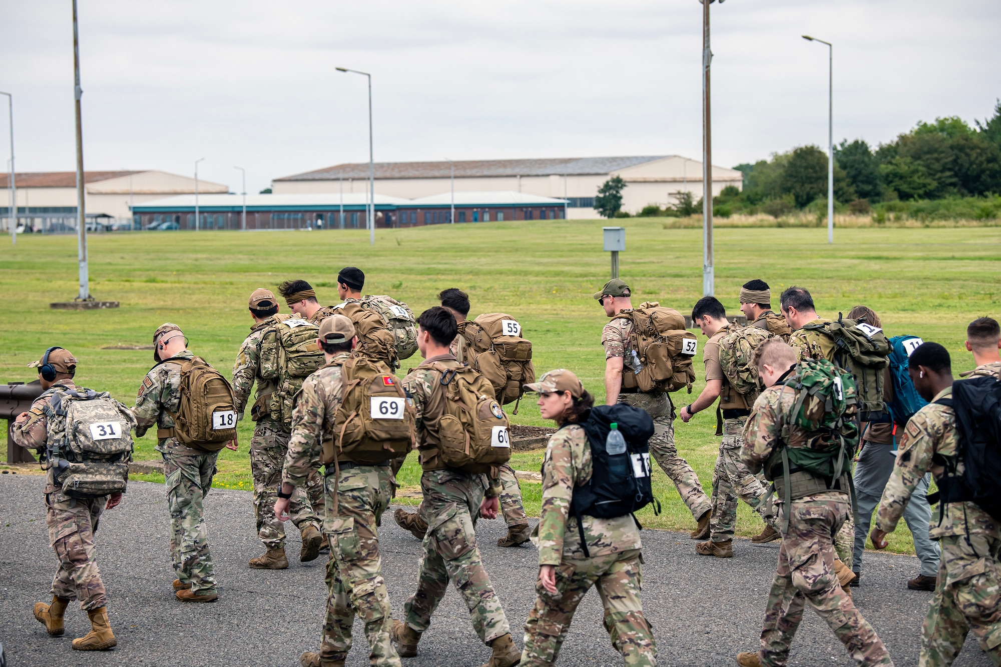 Participants complete a ruck march at RAF Molesworth, England, Aug. 18, 2023.Over 100 personnel from the 501st CSW and mission partner units participated in a 25 Kilometer Danish Contingent ruck march, which allowed them to test their physical capabilities and encouraged social bonds between joint forces. The DANCON ruck march has been completed in numerous countries throughout the world since it was established in 1972. (U.S. Air Force photo by Staff Sgt. Eugene Oliver)