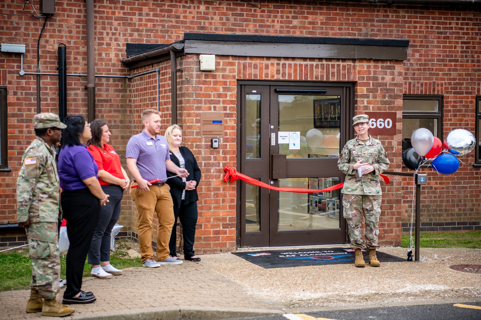 U.S. Air Force Col. Valarie Long, right, 423d Air Base Group commander, speaks during a ribbon cutting event at RAF Alconbury, England, Aug. 18, 2023. The ribbon cutting signified the opening of the new teen center. The teen center was reestablished to provide youth on base an additional outlet for social interaction and entertainment. (U.S. Air Force photo by Staff Sgt. Eugene Oliver)