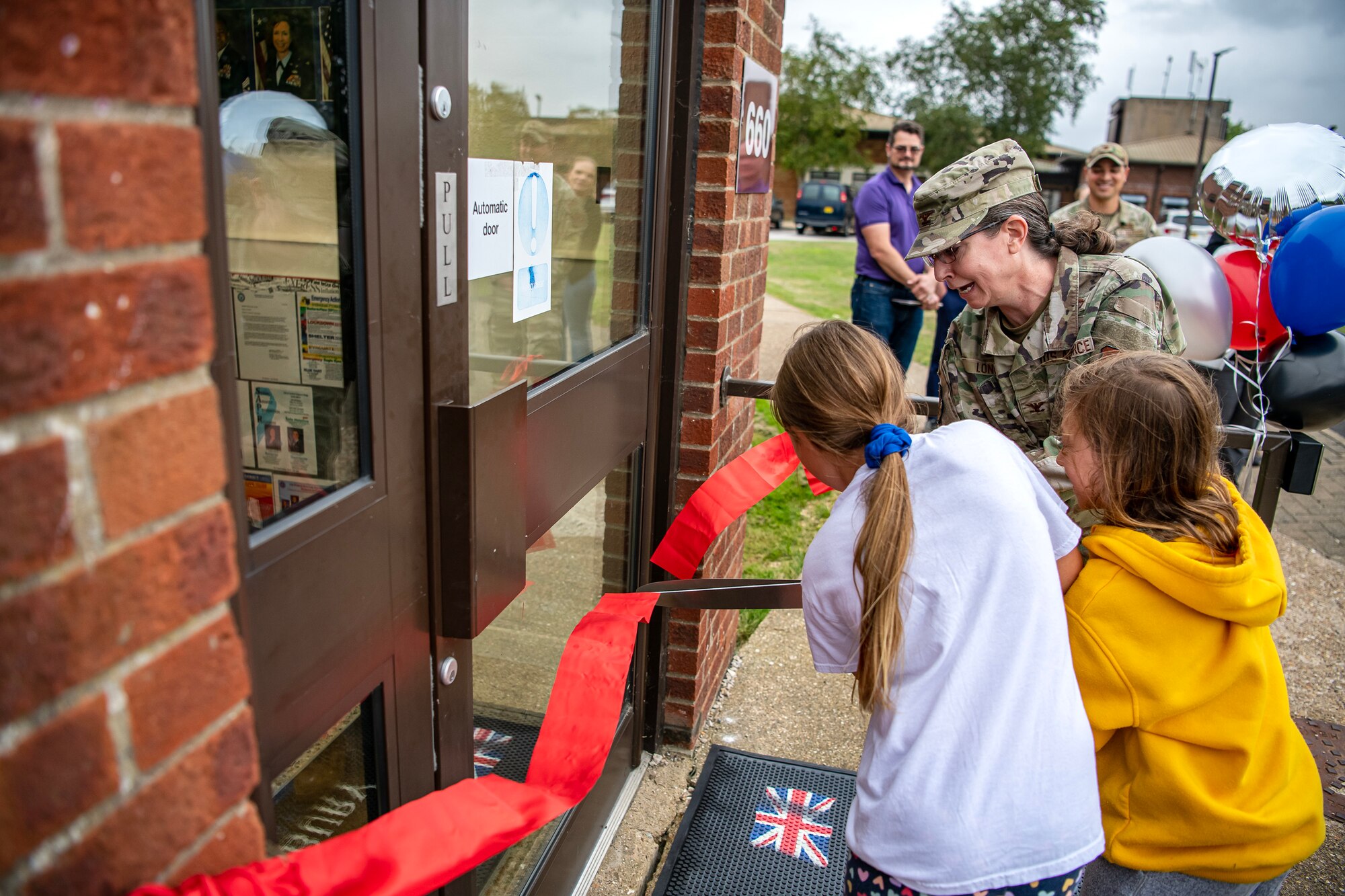 U.S. Air Force Col. Valarie Long, 423d Air Base Group commander cuts a ribbon at RAF Alconbury, England, Aug.18, 2023. The ribbon cutting signified the opening of the new teen center. The teen center was reestablished to provide youth on base an additional outlet for social interaction and entertainment. (U.S. Air Force photo by Staff Sgt. Eugene Oliver)