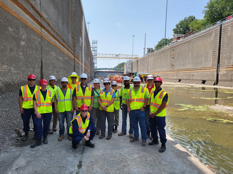 Members of the Brandon Road Interbasin Project Technical Team stand a the bottom of the dewatered lock chamber.