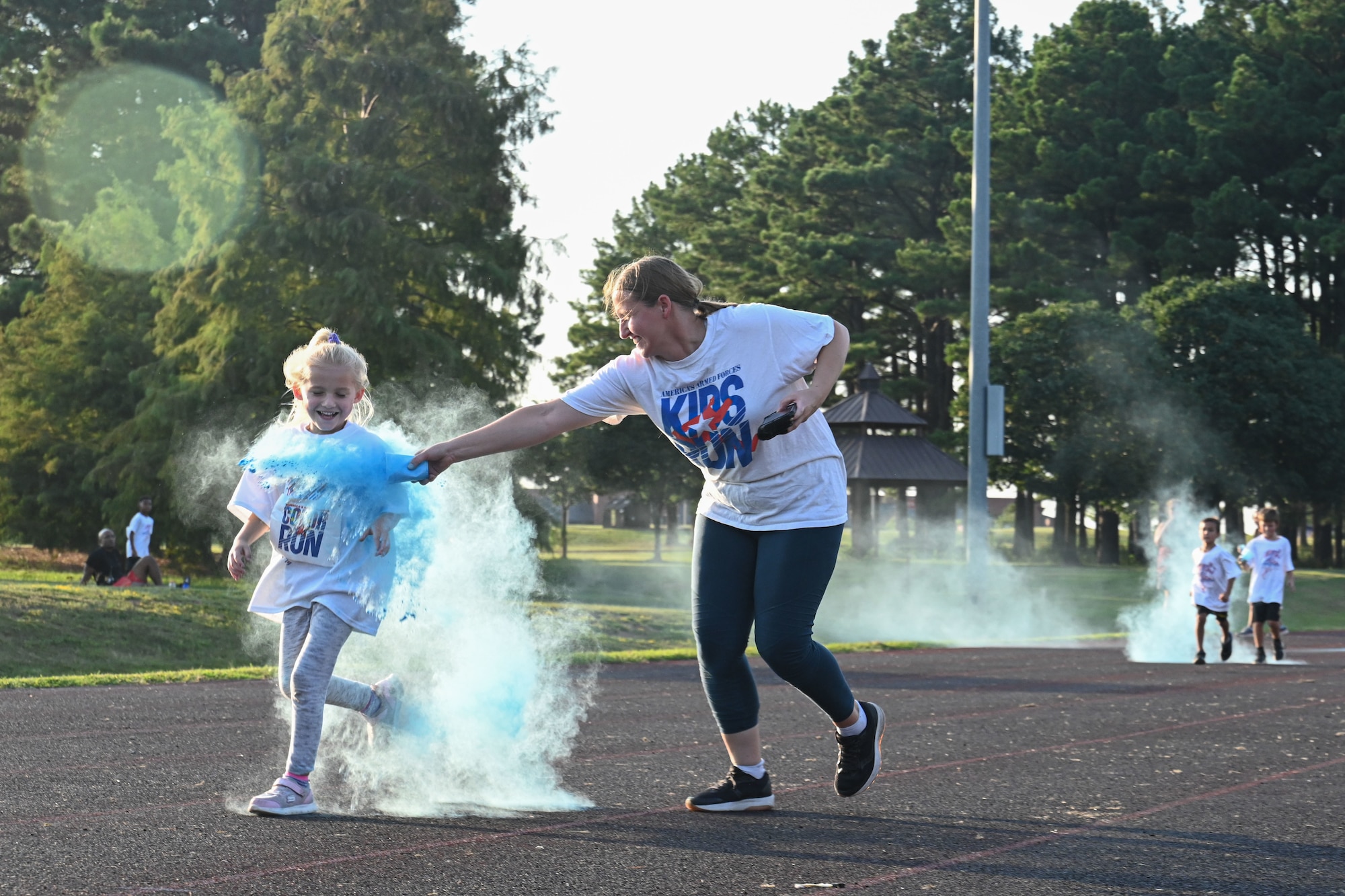 a member tosses colored powder on a child