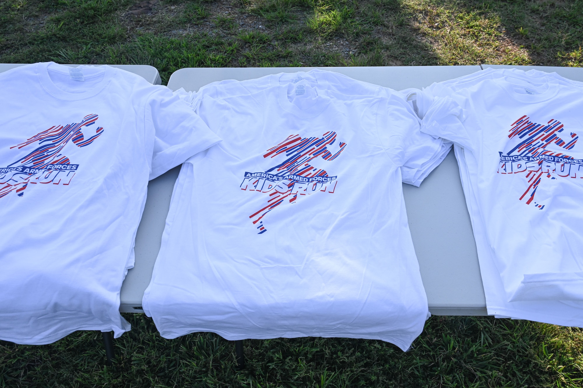 white shirts are displayed on a table
