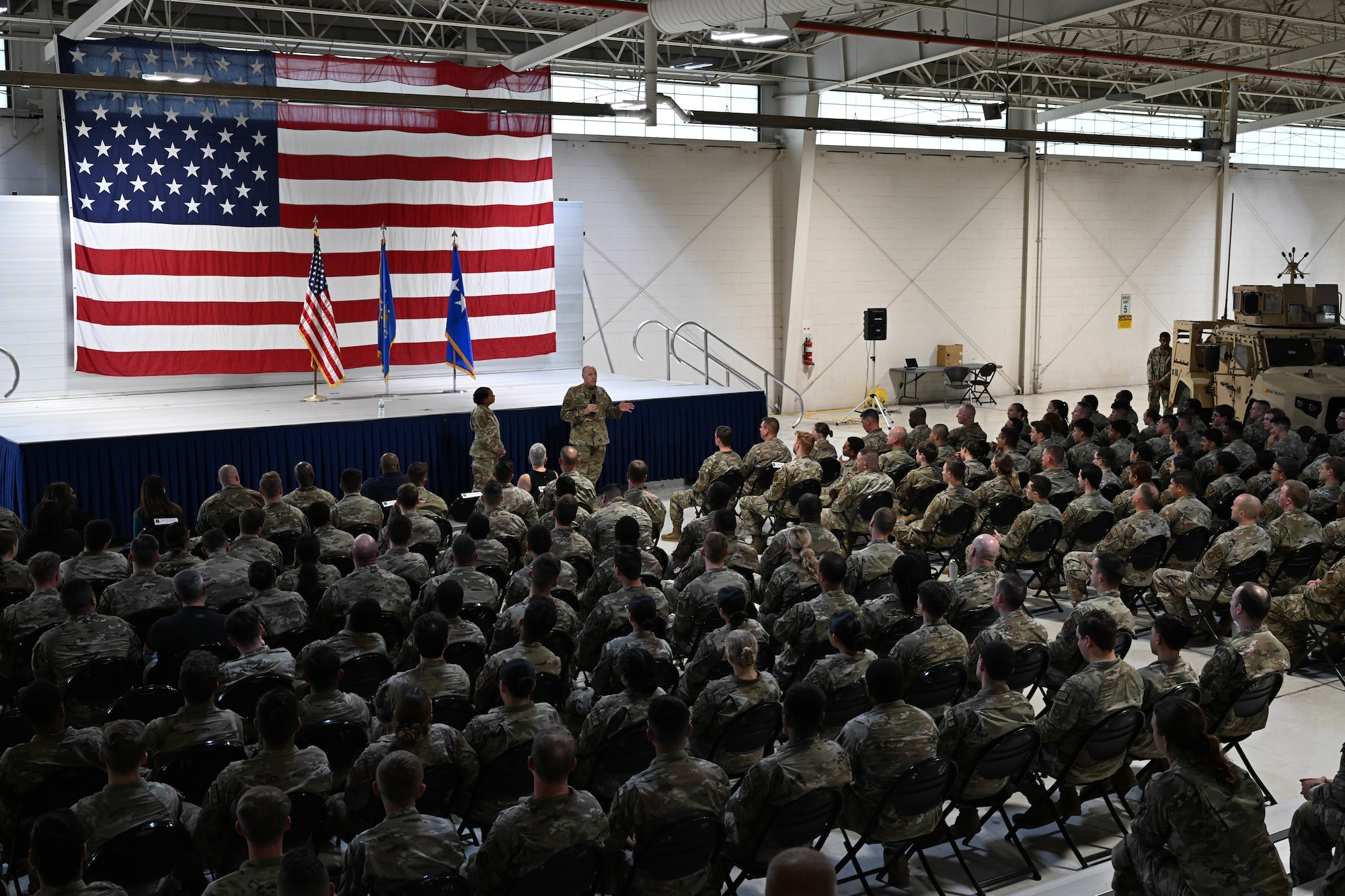 U.S. Air Force Gen. Thomas Bussiere, Air Force Global Strike Command commander, and Chief Master Sgt. Melvina Smith, AFGSC command chief, conduct an all-call during a base tour at Minot Air Force Base, North Dakota, Aug. 16, 2023. During the event, Airmen got to know AFGSC leadership and were able to ask questions about the command. (U.S. Air Force photo by Airman 1st Class Kyle Wilson)