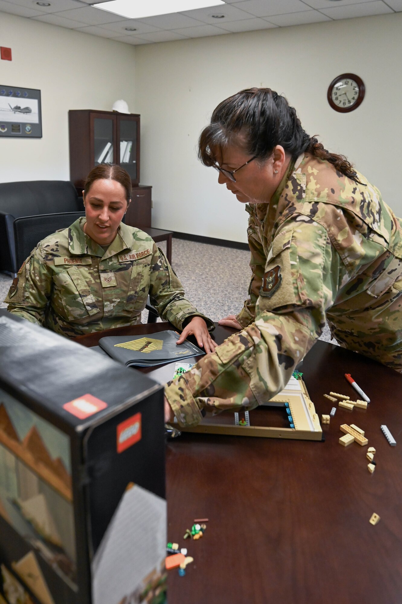 Col. Summer Fields, 434th Air Refueling Wing commander, shows Staff Sgt. Marina Phoenix, 434th Maintenance Support Group command support staff journeyman, the progress that has been made to her Great Pyramid of Giza LEGO set at Grissom Air Reserve Base, Ind., August 5, 2023. Fields uses this activity as an opportunity to connect with airmen and ease tension that they might have upon walking into her office for the first time. (U.S. Air Force photo by Senior Airman Alexis M. Morris)