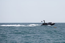 A Long Range Unmanned Surface Vessel, shown here with a small Unmanned Surface Vessel in the foreground, semi-autonomously navigates open waters during an Early Operational Test event April 26, 2023, roughly ten miles off the coast of Joint Expeditionary Base Little Creek/Fort Story, Virginia. (U.S. Marine Corps photo by Jim Van Meer)