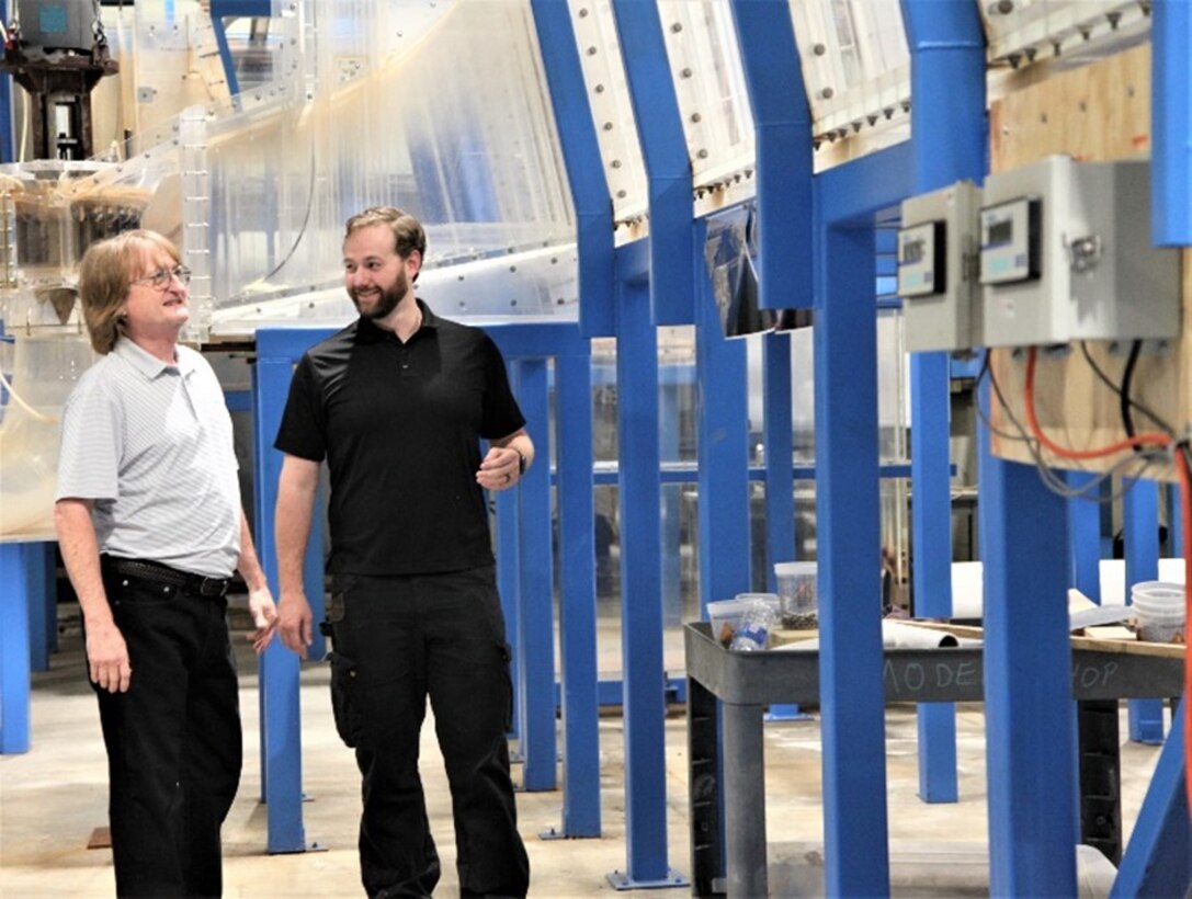 During his tour of Vicksburg’s campus, Portland District’s Garrett Hall, right, visited the Coastal and Hydraulics Laboratory (CHL), where he will be based for his six-month ERDC University project. He met with CHL Navigation Division’s Robert Davidson, left, to view the working model of The Dalles Dam, where Hall serves as the senior mechanical engineer.