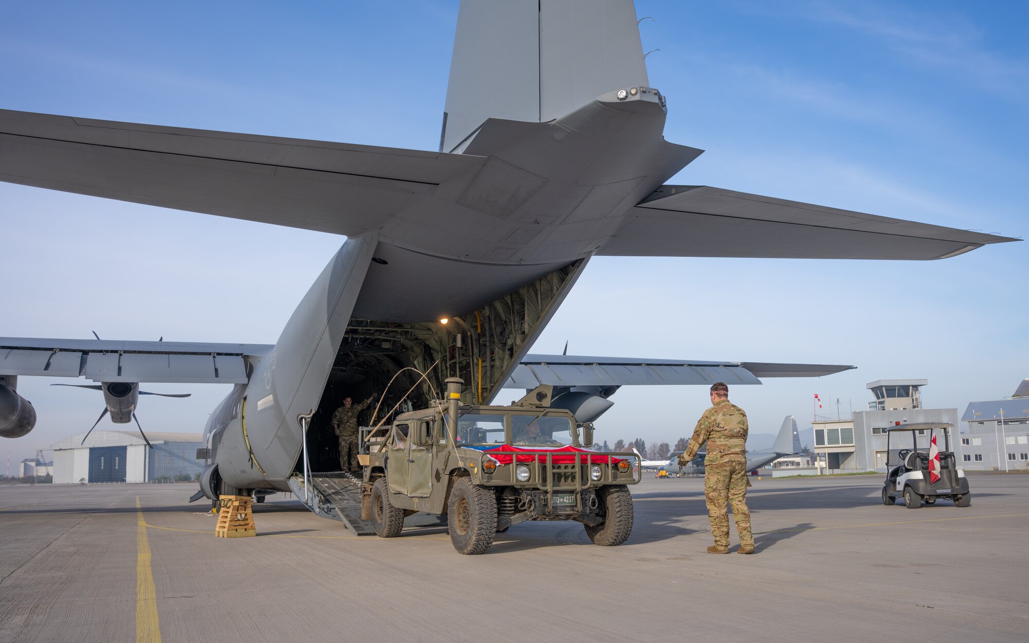 A Chilean Armed Forces Humvee is loaded onto a C-130J Super Hercules from the 39th Airlift Squadron out of the 317th Airlift Wing, Dyess AFB, TX on a runway at the Santiago de Chile Airport, Santiago, Chile, July 28, 2023, during exercise Southern Star 23. Exercise Southern Star 23 is a Chilean-led full-scale Special Operations, Joint, and Combined Employment Exercise. The training consists of staff planning, tactical maneuvers, and collaboration among SOUTHCOM components’ staff, Chilean Armed Forces, and interagency partners during a stabilization scenario which facilitates the opportunity for participants to execute and assess the staff’s ability to plan, coordinate and execute command and control, logistical support, and decision-making processes in a crisis scenario. (U.S. Air Force photo by Staff Sgt. Clayton Wear)