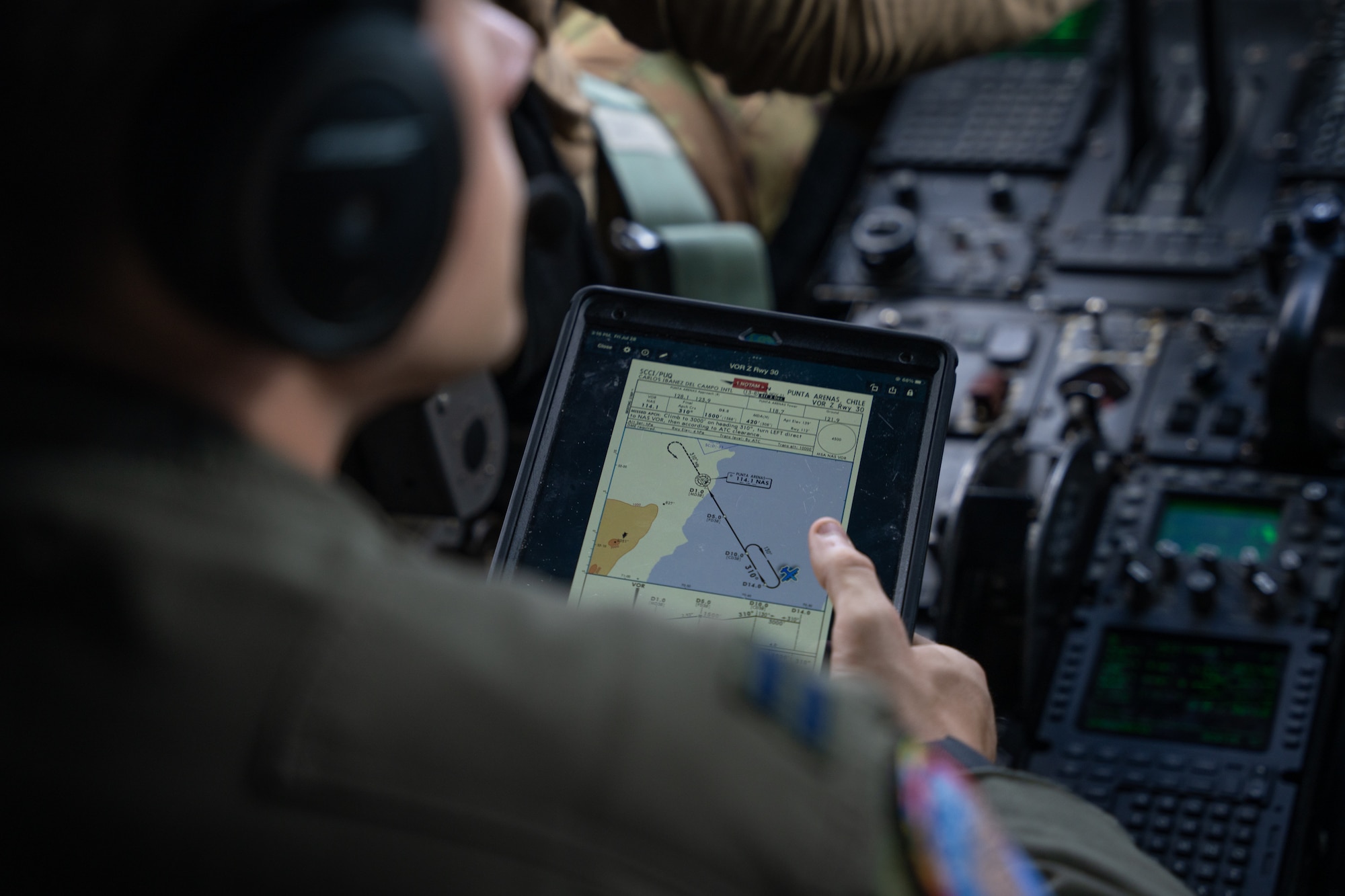 A C-130J Super Hercules pilot from the 39th Airlift Squadron out of the 317th Airlift Wing, Dyess AFB, TX reads the landing chart for Punta Arenas, Chile while the crew flies south of Santiago, Chile, July 28, 2023, during exercise Southern Star 23. Exercise Southern Star 23 is a Chilean-led full-scale Special Operations, Joint, and Combined Employment Exercise. The training consists of staff planning, tactical maneuvers, and collaboration among SOUTHCOM components’ staff, Chilean Armed Forces, and interagency partners during a stabilization scenario which facilitates the opportunity for participants to execute and assess the staff’s ability to plan, coordinate and execute command and control, logistical support, and decision-making processes in a crisis scenario. (U.S. Air Force photo by Staff Sgt. Clayton Wear)