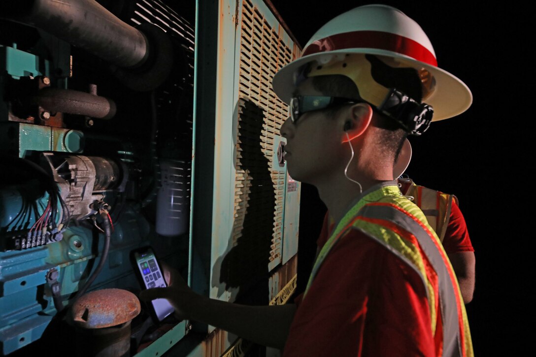 Kenny Kwan,  quality assurance representative deployed with the U.S. Army Corps of Engineers Temporary Emergency Power Team, performs a quality assurance inspection of a generator at a water pump station on Maui, Aug 21. The USACE  is working in partnership with the local and federal response to the Hawaii Wildfires.